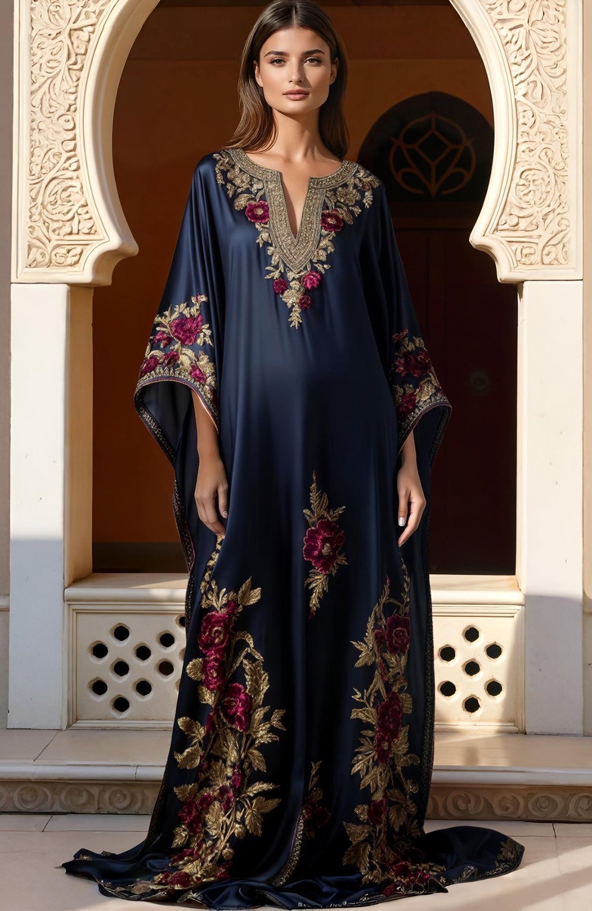Navy blue kaftan dress with gold and burgundy floral embroidery and wide flowing sleeves.