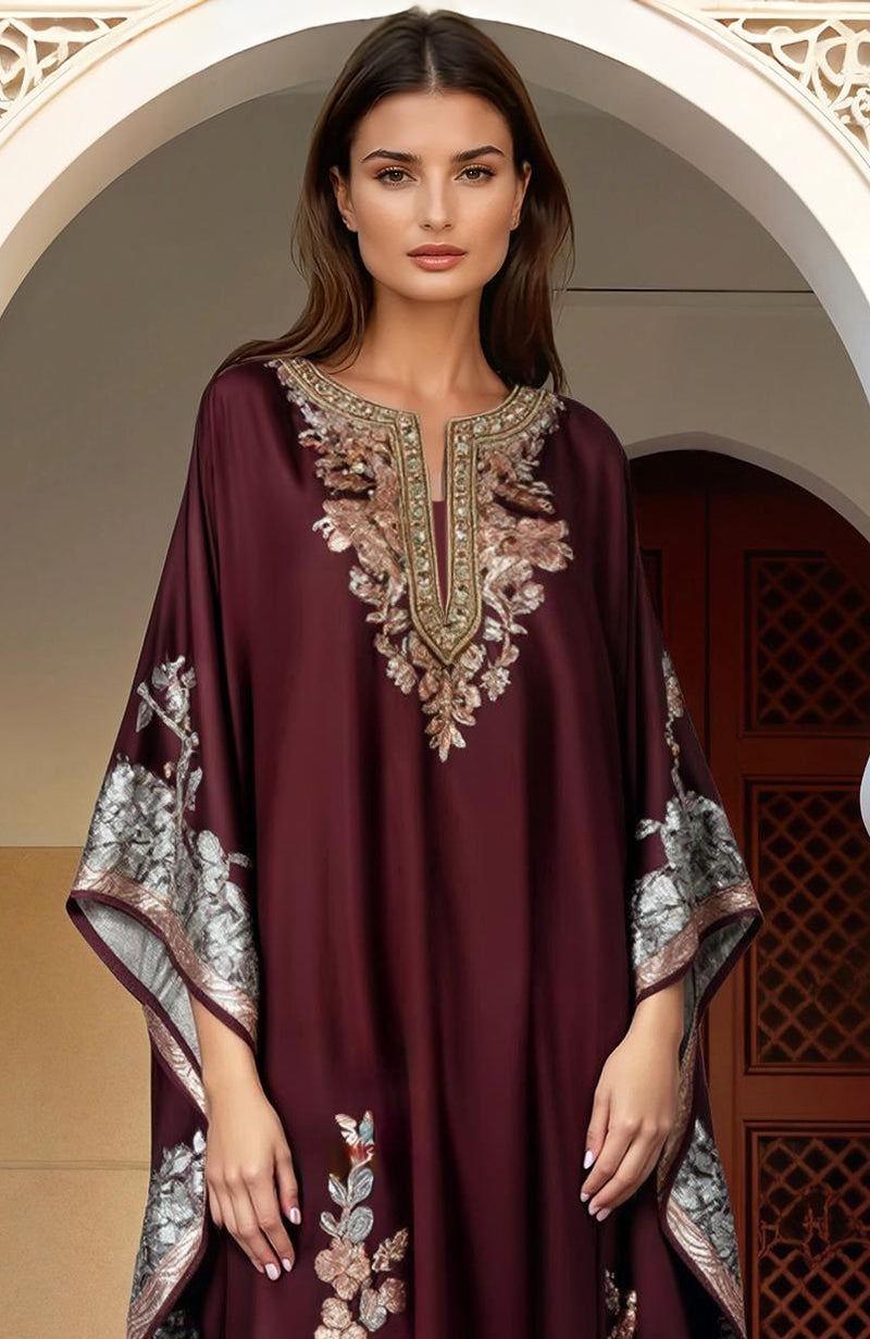 Burgundy floor-length kaftan with gold and silver floral embroidery and wide flowing sleeves