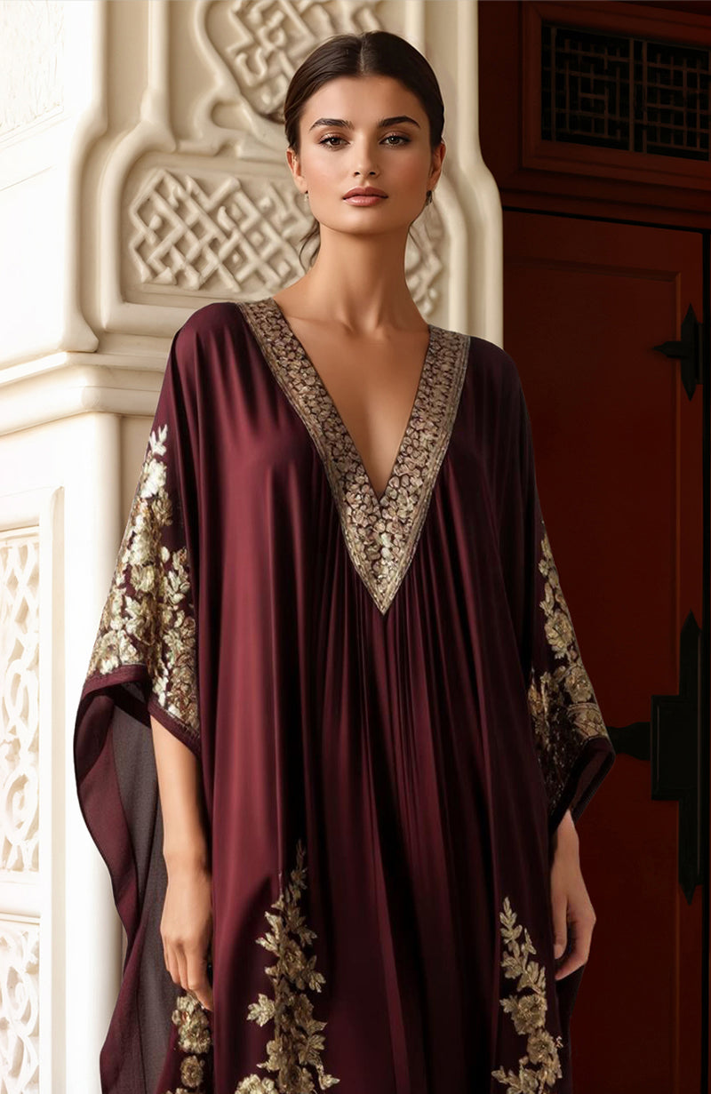 Deep burgundy kaftan with gold Kashmiri tilla embroidery, deep V-neck, and wide sleeves.