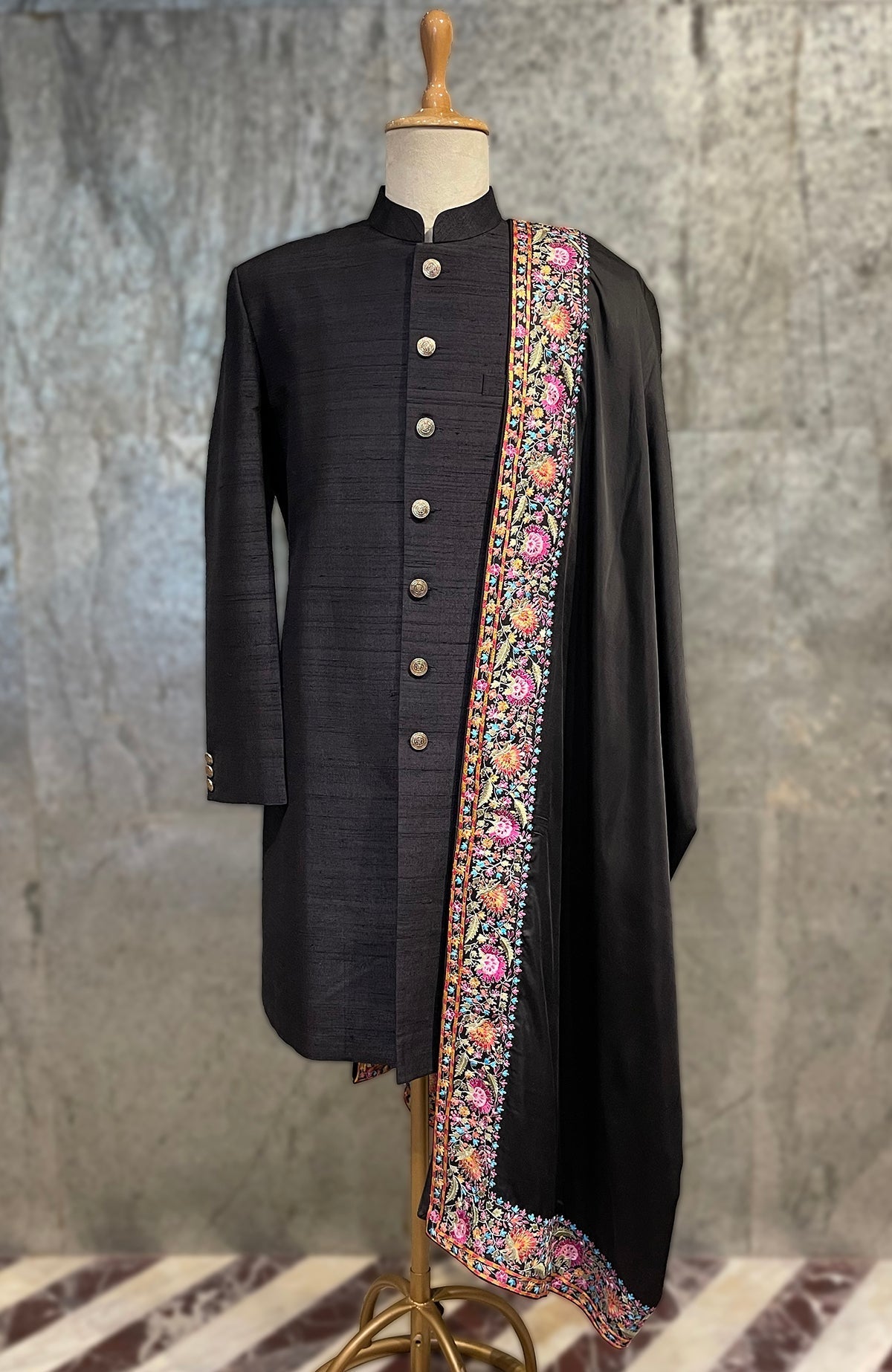 Black Kashmir Bagh Kashidakari embroidered shawl draped over a black sherwani.