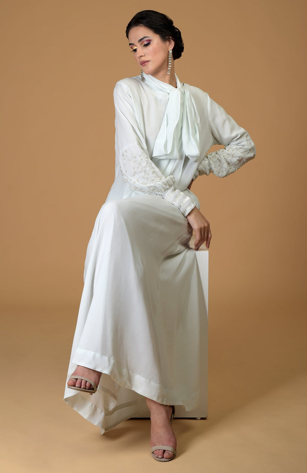 Ash grey silk georgette gown with hand-embroidered sleeves and an elongated neck scarf.