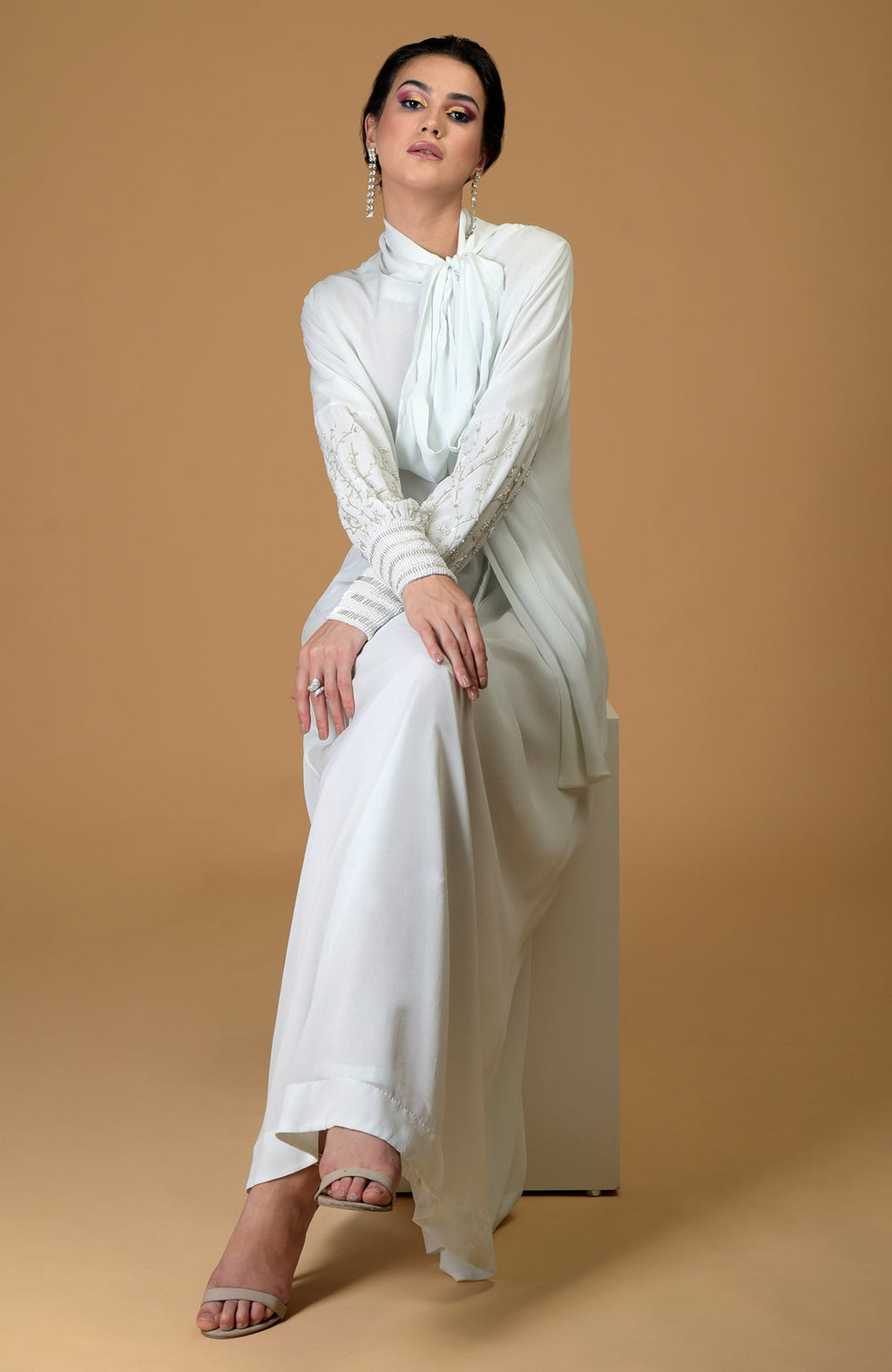 Ash grey silk georgette gown with hand-embroidered sleeves and an elongated neck scarf.