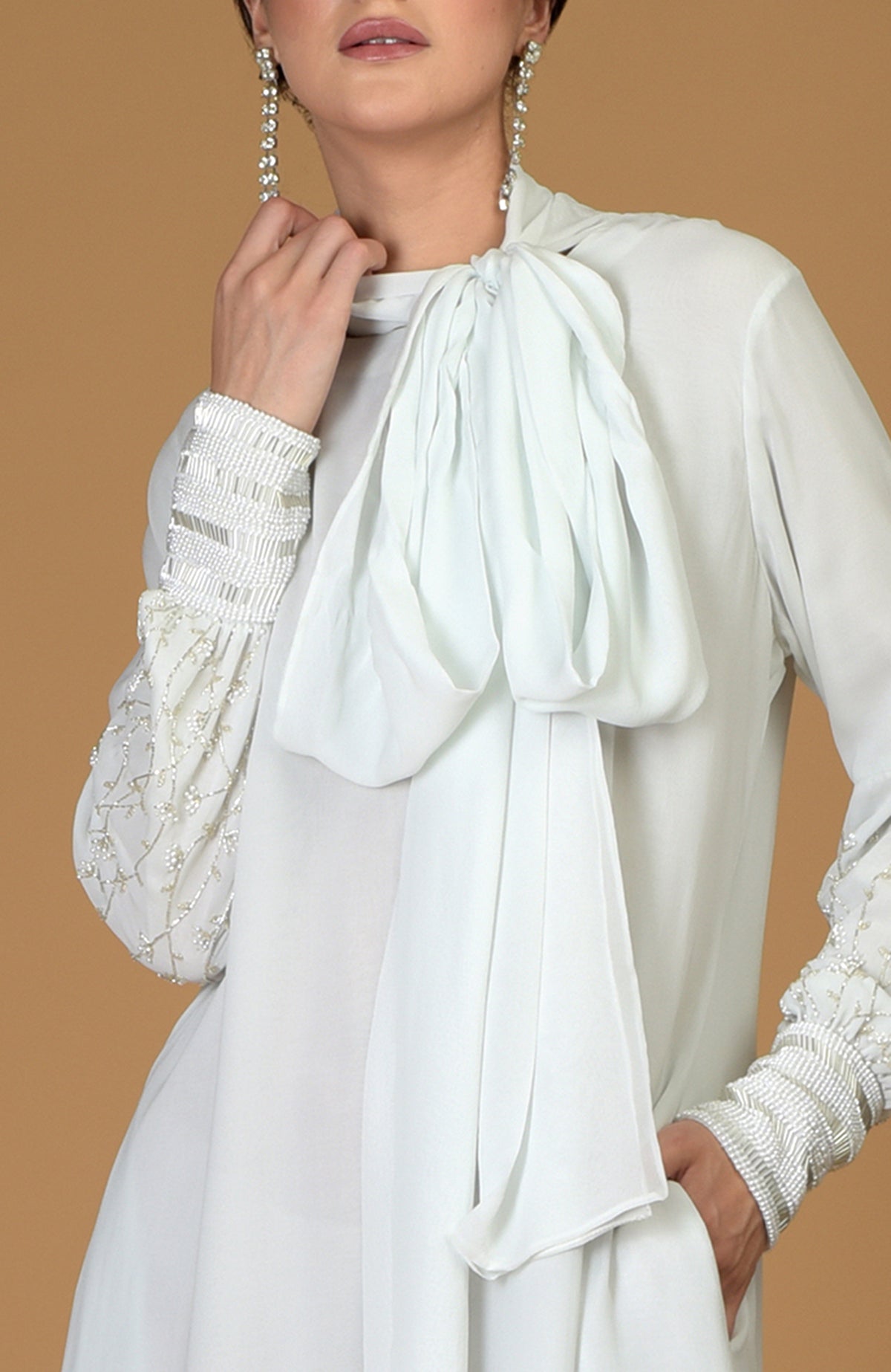 Ash grey silk georgette dress with pearl and bead embellished sleeves and a neck scarf.