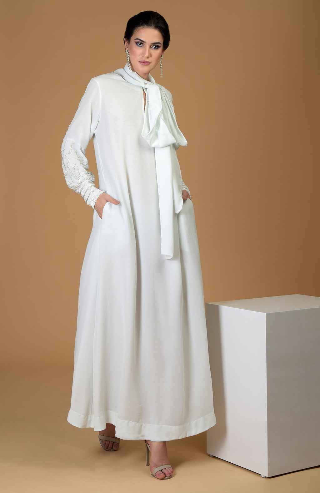 Ash grey silk georgette gown with hand-embroidered sleeves and an elongated neck scarf.