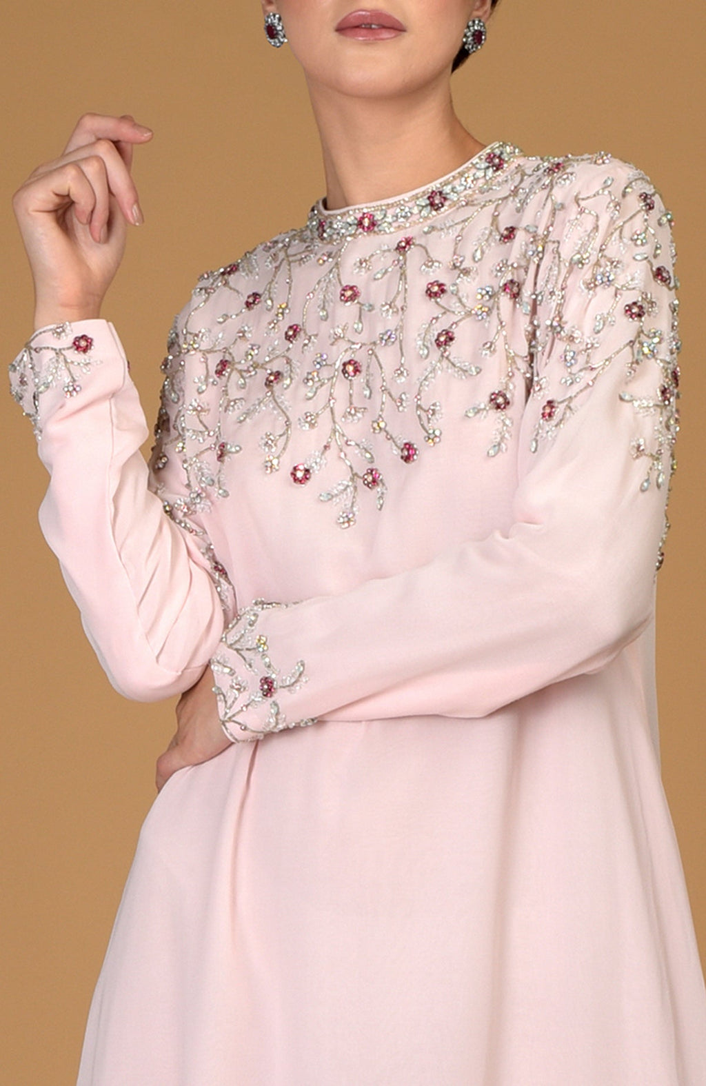 Pale pink dress with intricate crystal and bead embroidery on the neckline, yoke, and sleeves.