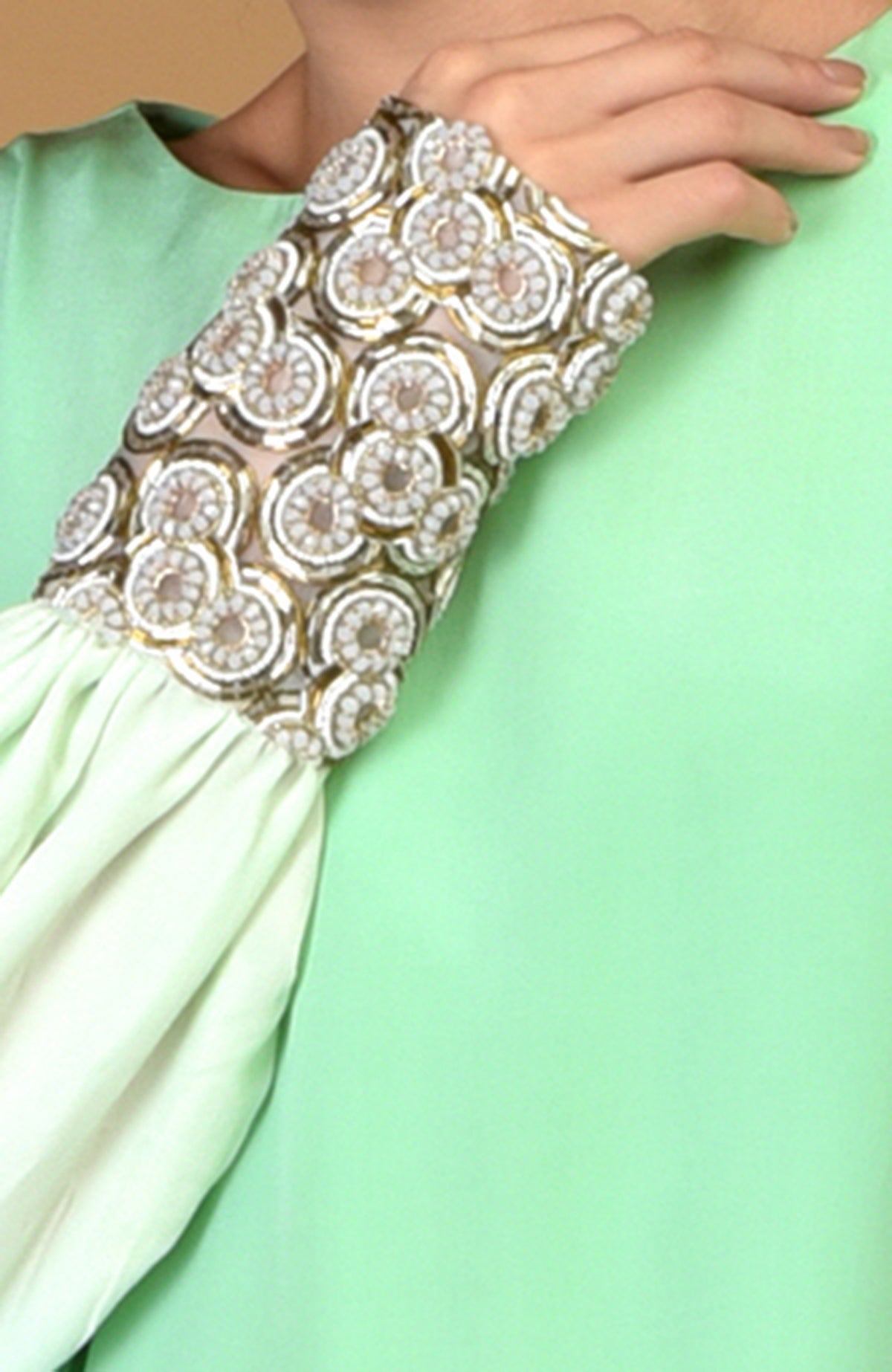 Sage green dress with sparkling circular jeweled cuffs.