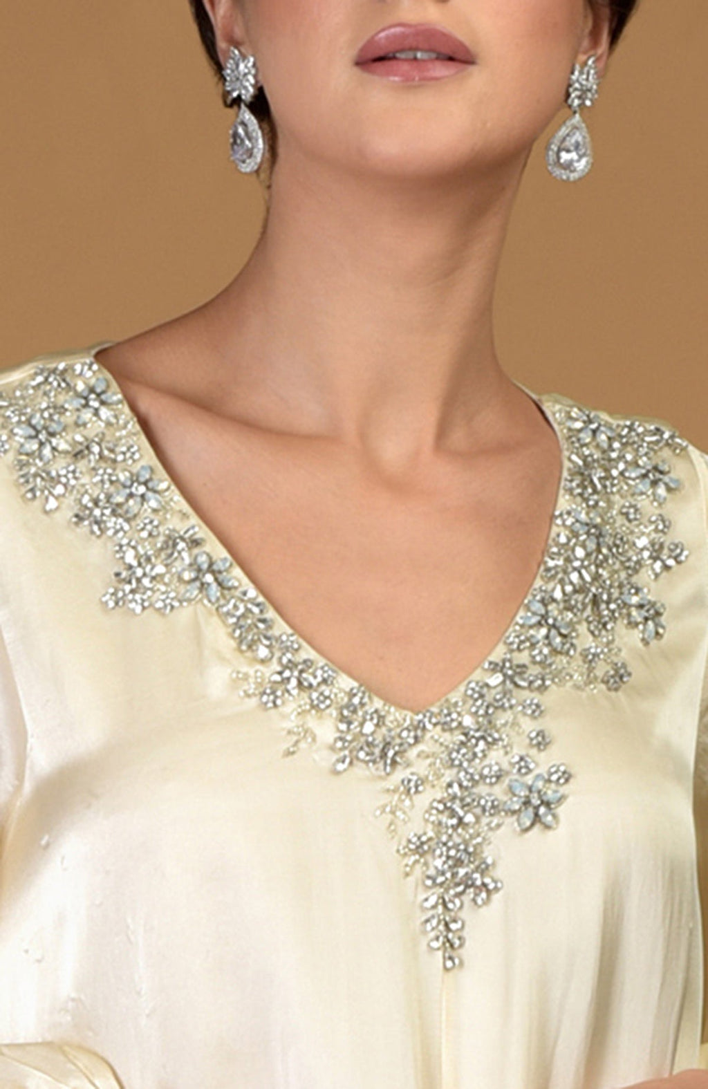 White gold dress with a crystal cluster hand-embroidered V-neckline and matching earrings.