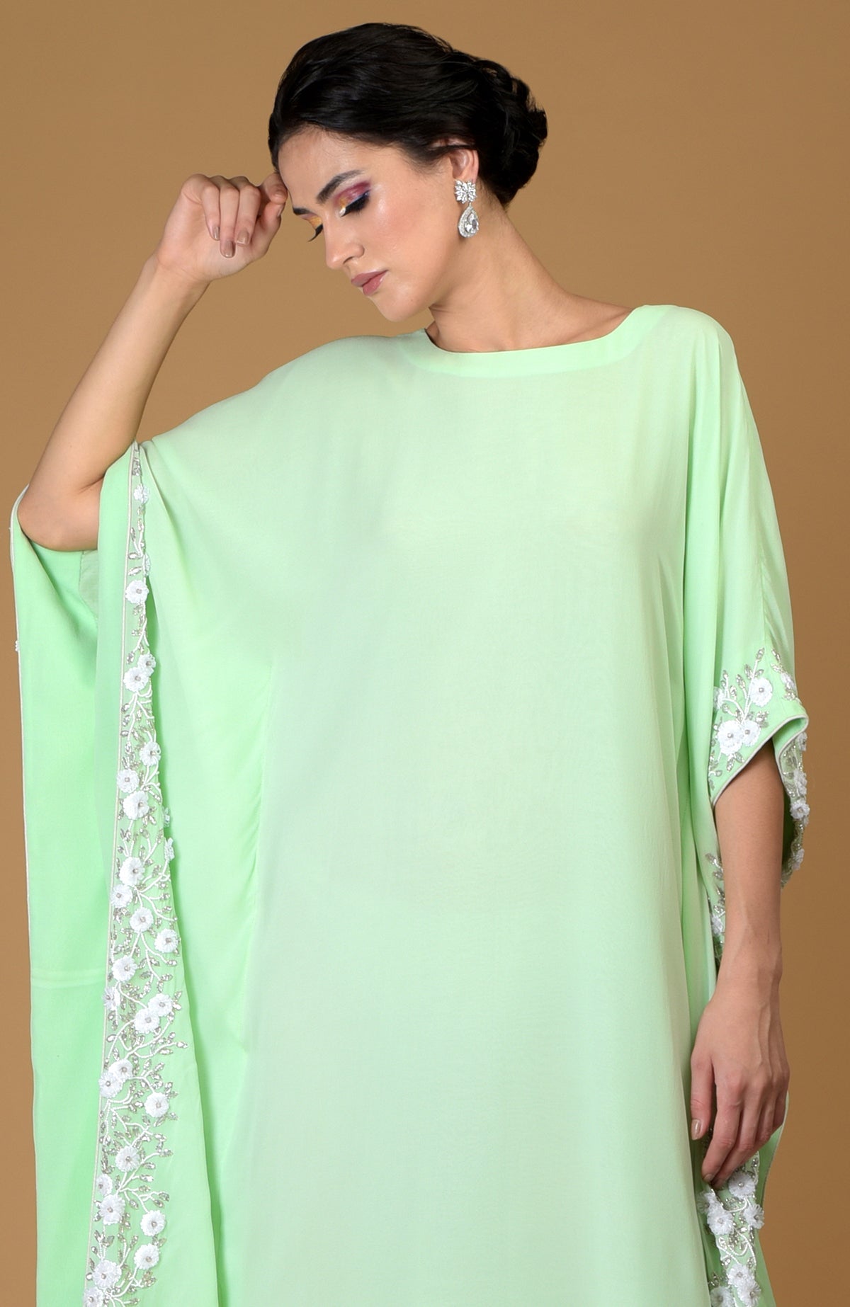 Mint green kaftan dress with white floral hand embroidery.