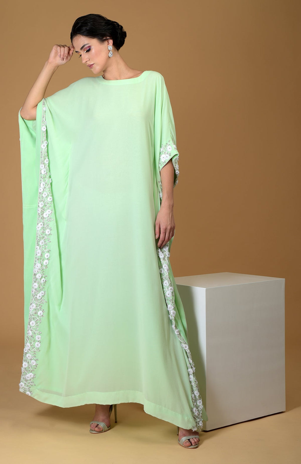 Mint green kaftan dress with white floral and vine hand embroidery.