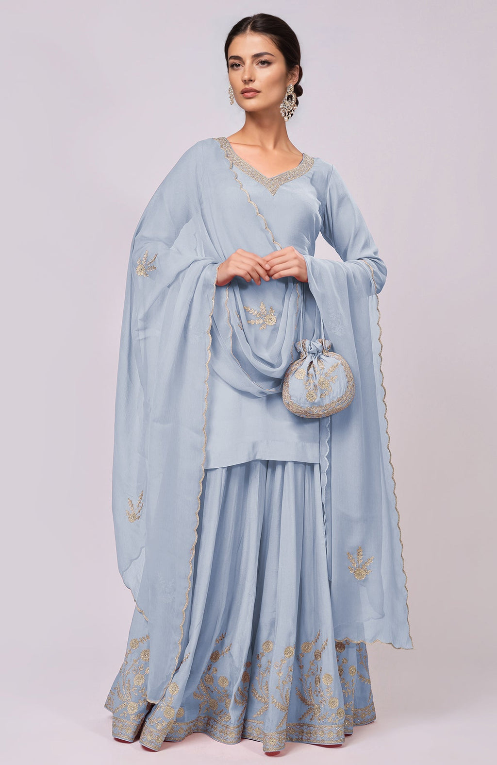 Light blue sharara set with gold embroidery and a matching potli bag.