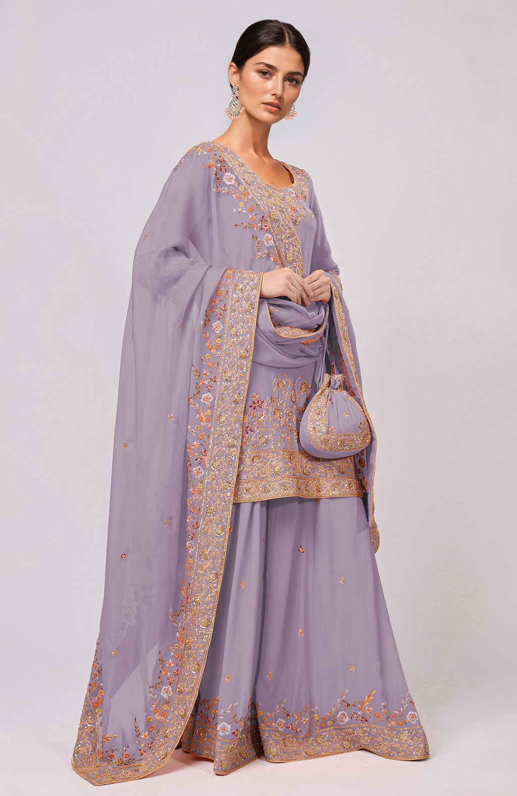 A woman models an elderberry sharara set with intricate marori and resham embroidery.