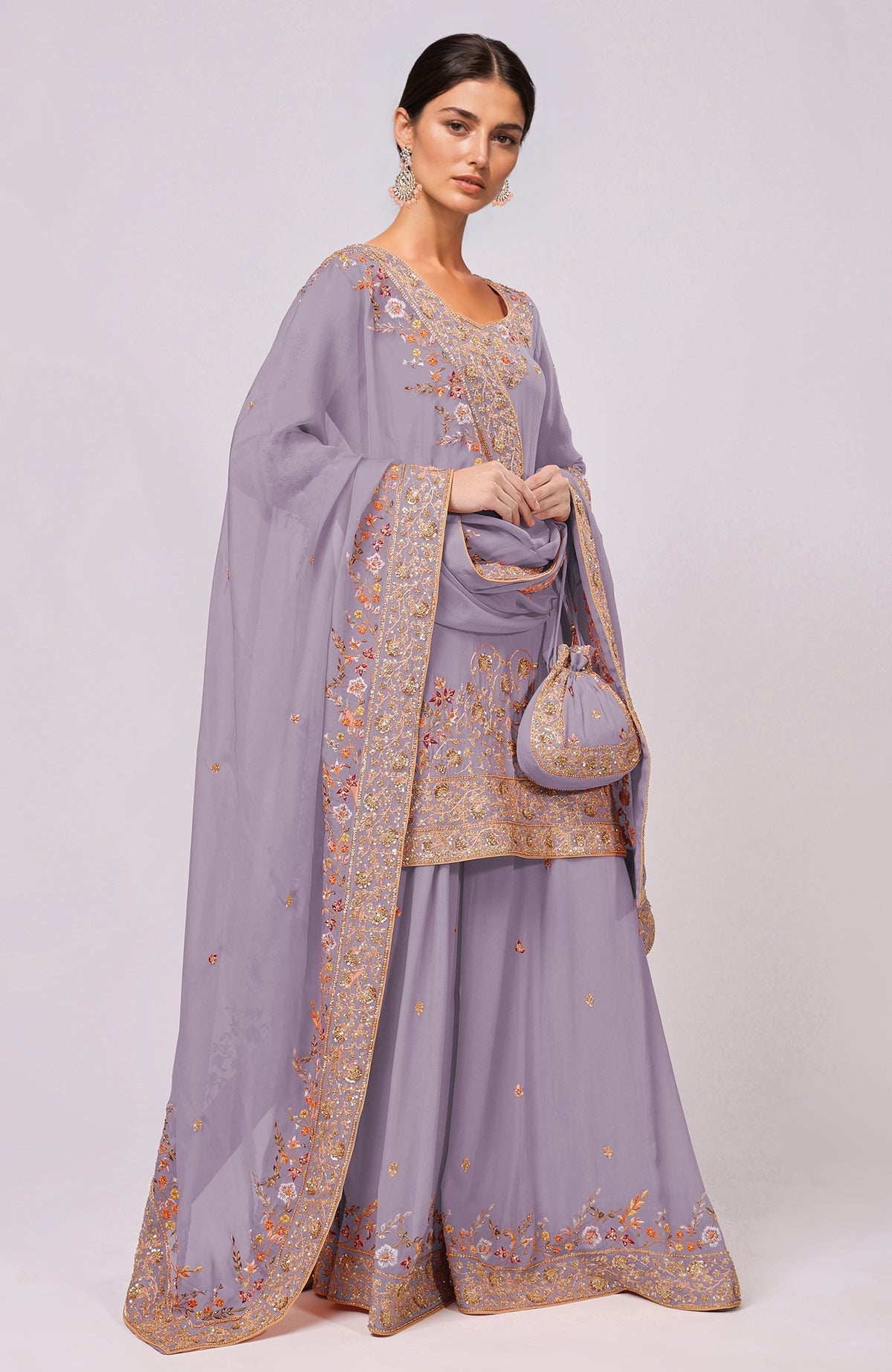 A woman models an elderberry sharara set with intricate marori and resham embroidery.