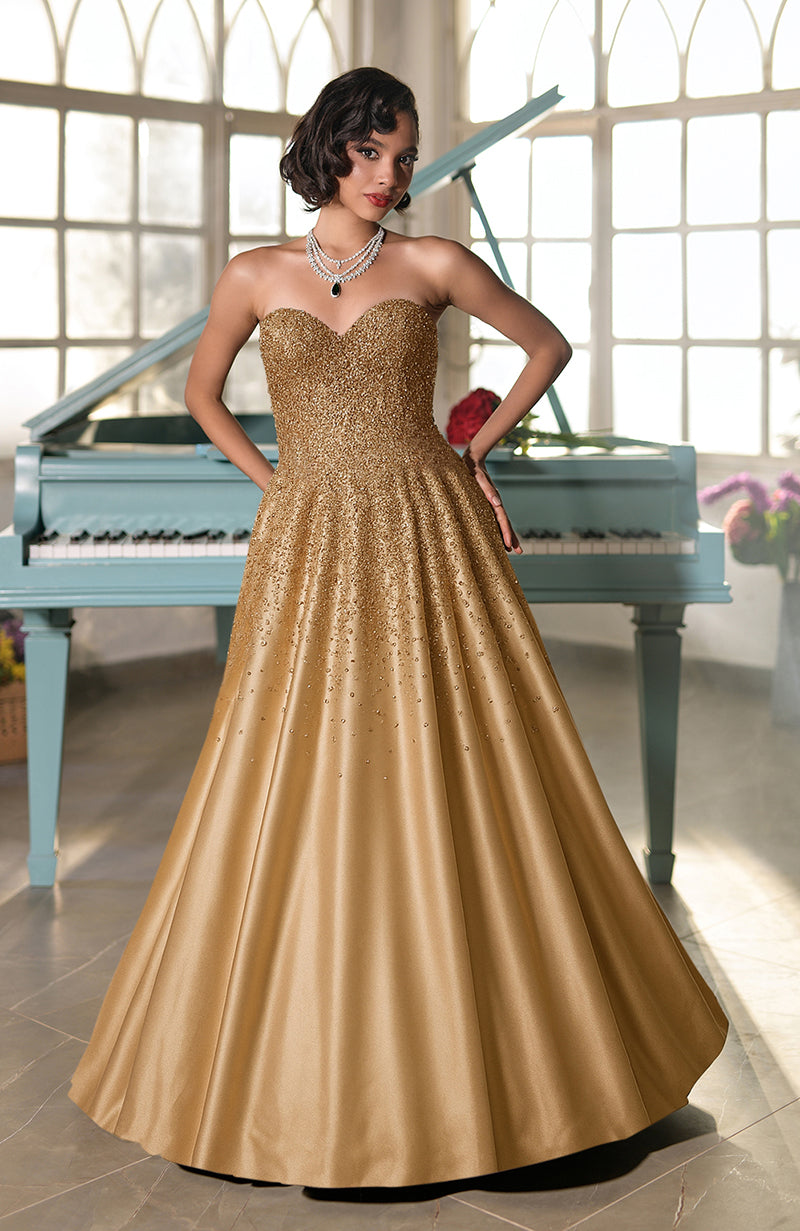Strapless golden ball gown with crystal hand embroidery and a voluminous skirt.