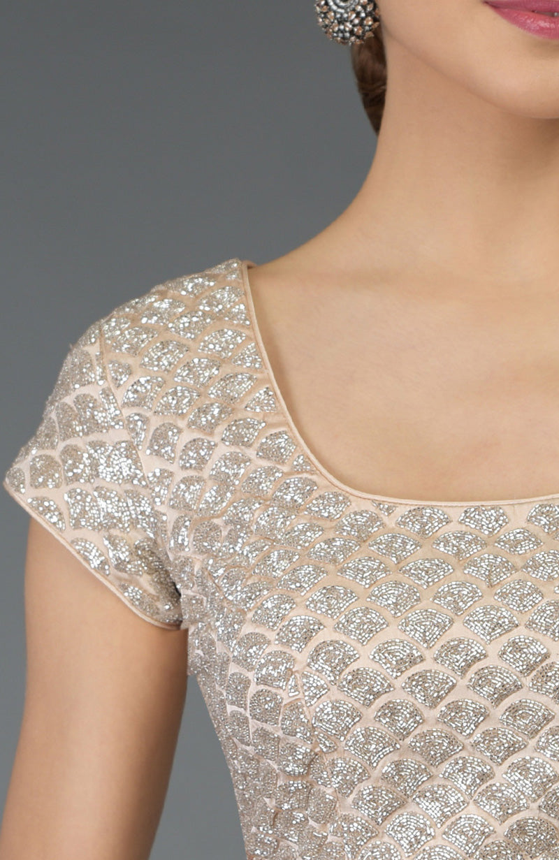 Nude peach blouse with silver zardozi hand embroidery in a scalloped pattern.