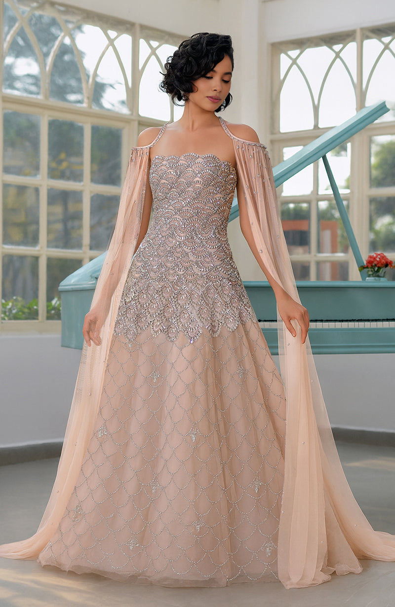 Strapless nude princess gown with hand-embroidered crystals, beads, and a sheer beaded cape