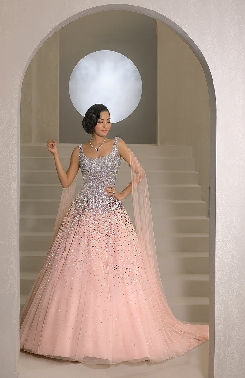 Pink princess gown with hand-embroidered crystals, pearls, and a sheer cape.