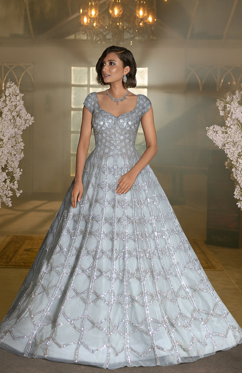 Blue princess gown with hand-embroidered crystals and sequins, sweetheart neckline, and cap sleeves.
