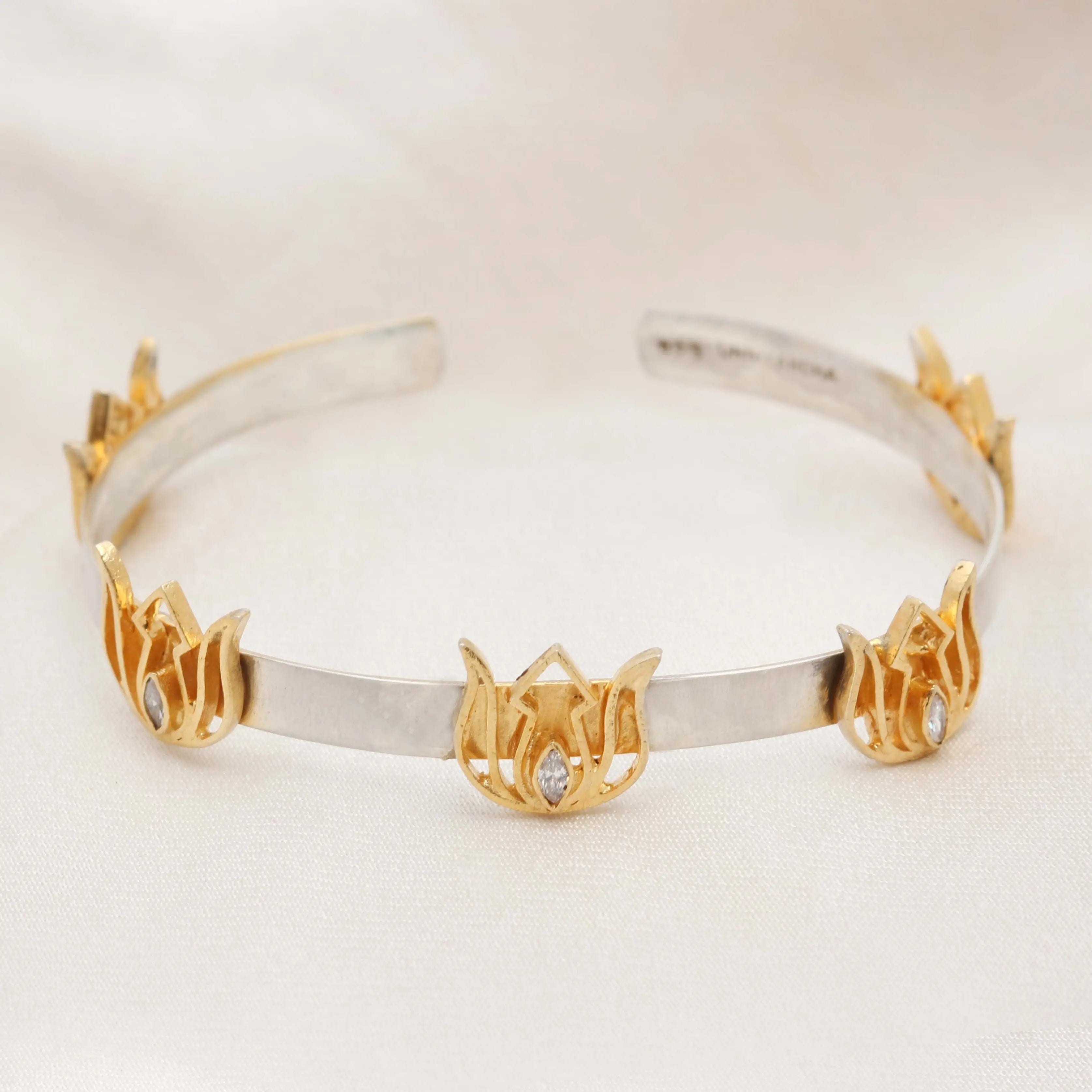 Sterling silver bracelet featuring a gold-plated lotus centerpiece, handcrafted with detailed finish