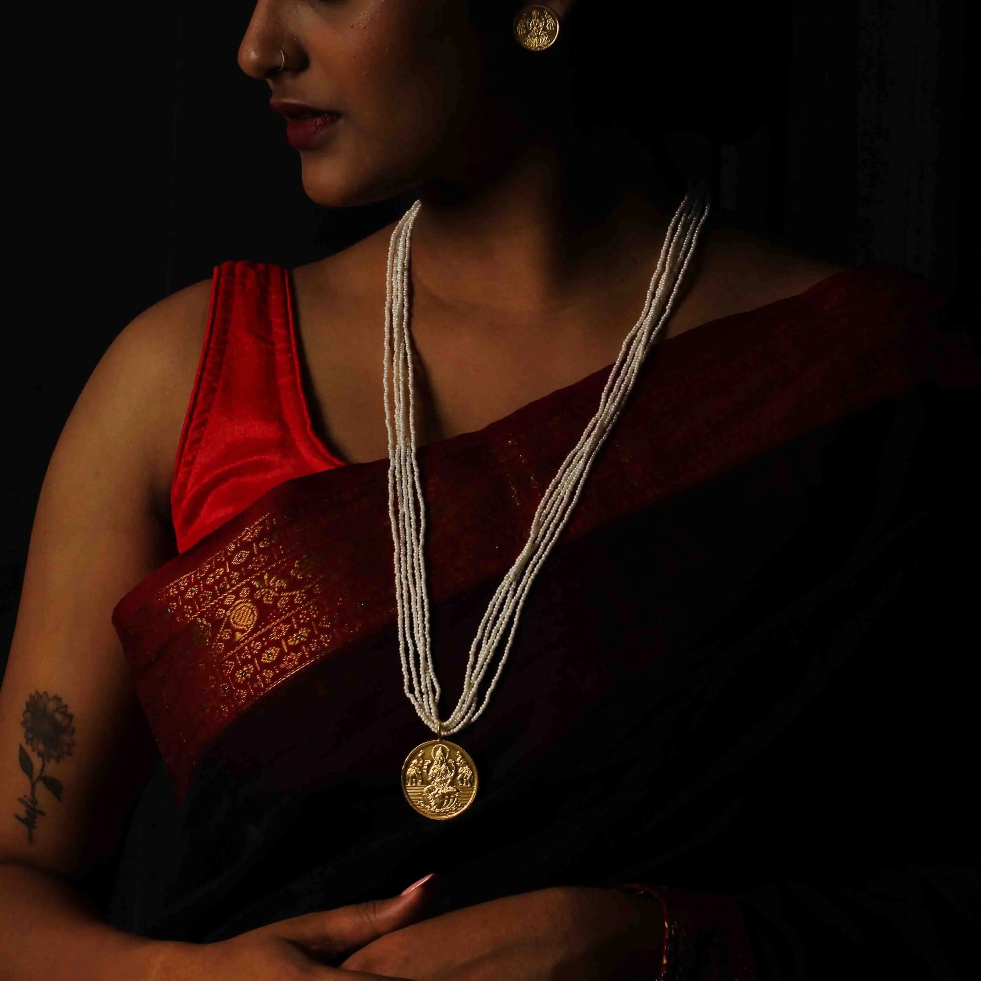 Kuber-inspired long pearl necklace in 92.5 silver, featuring intricate gold-plated motifs