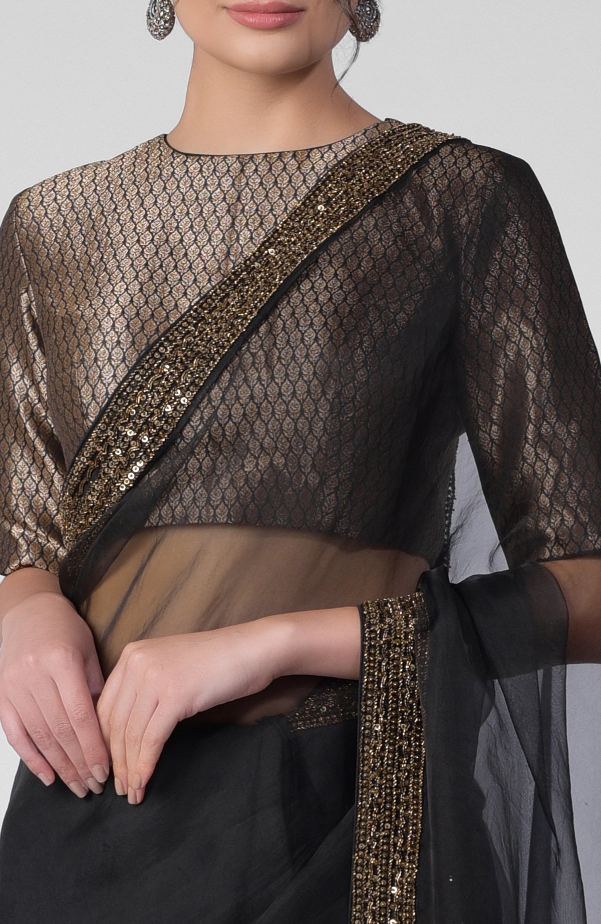 Black silk organza saree with gold hand embroidered zardozi border and brocade blouse