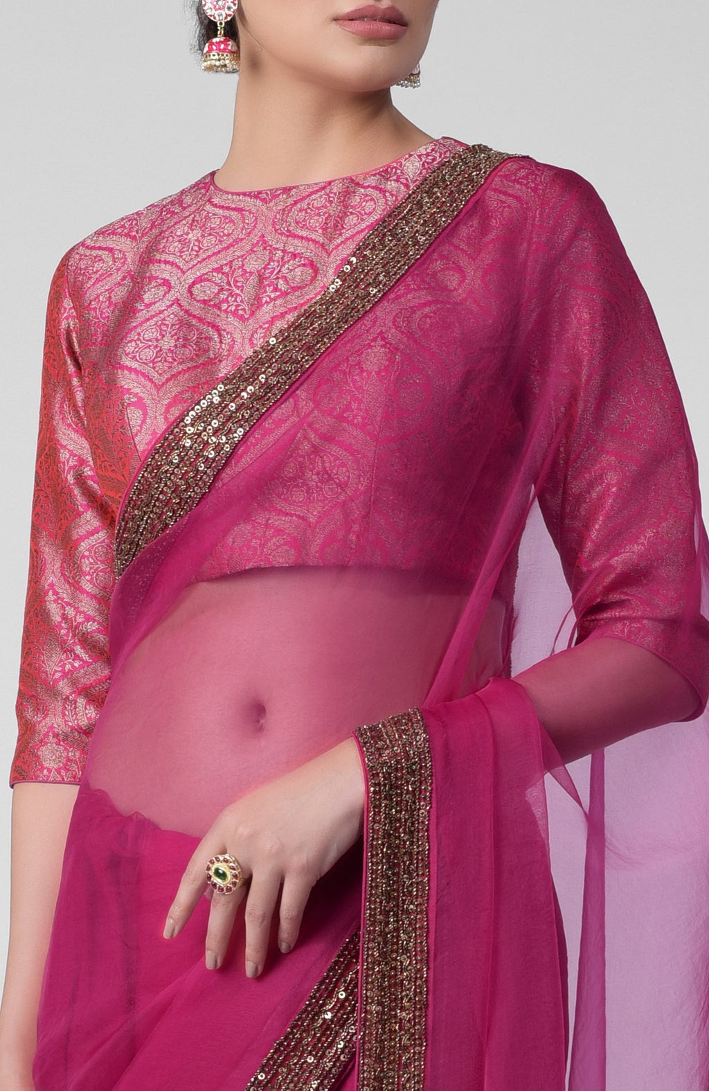 Fuchsia silk organza saree with gold zardozi border and silk brocade blouse with jewel neckline