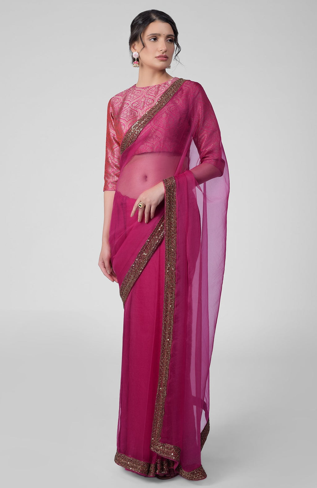 Fuchsia silk organza saree with gold zardozi border and silk brocade blouse with jewel neckline