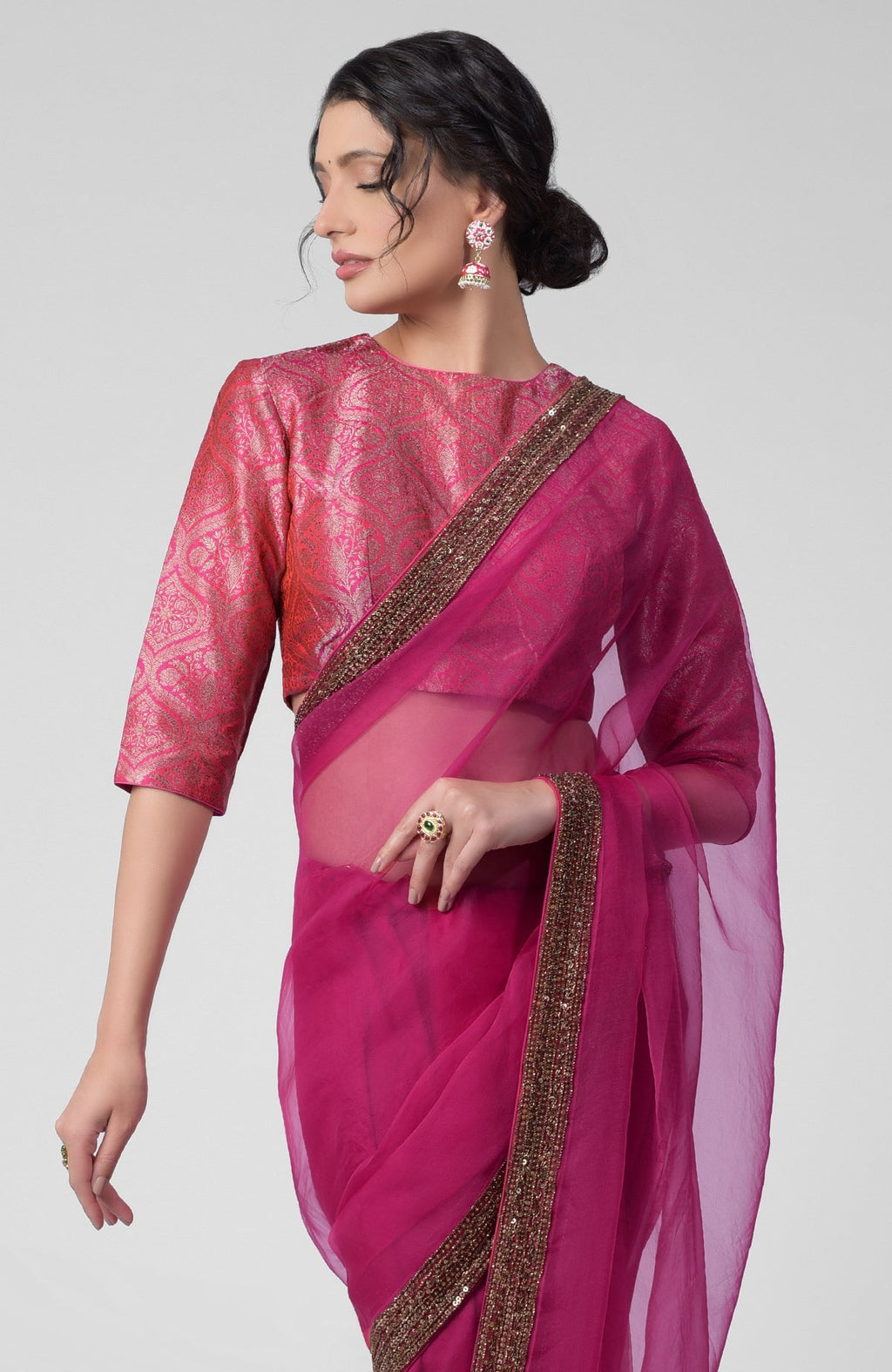 Fuchsia silk organza saree with gold zardozi embroidery and silk brocade blouse with potli buttons