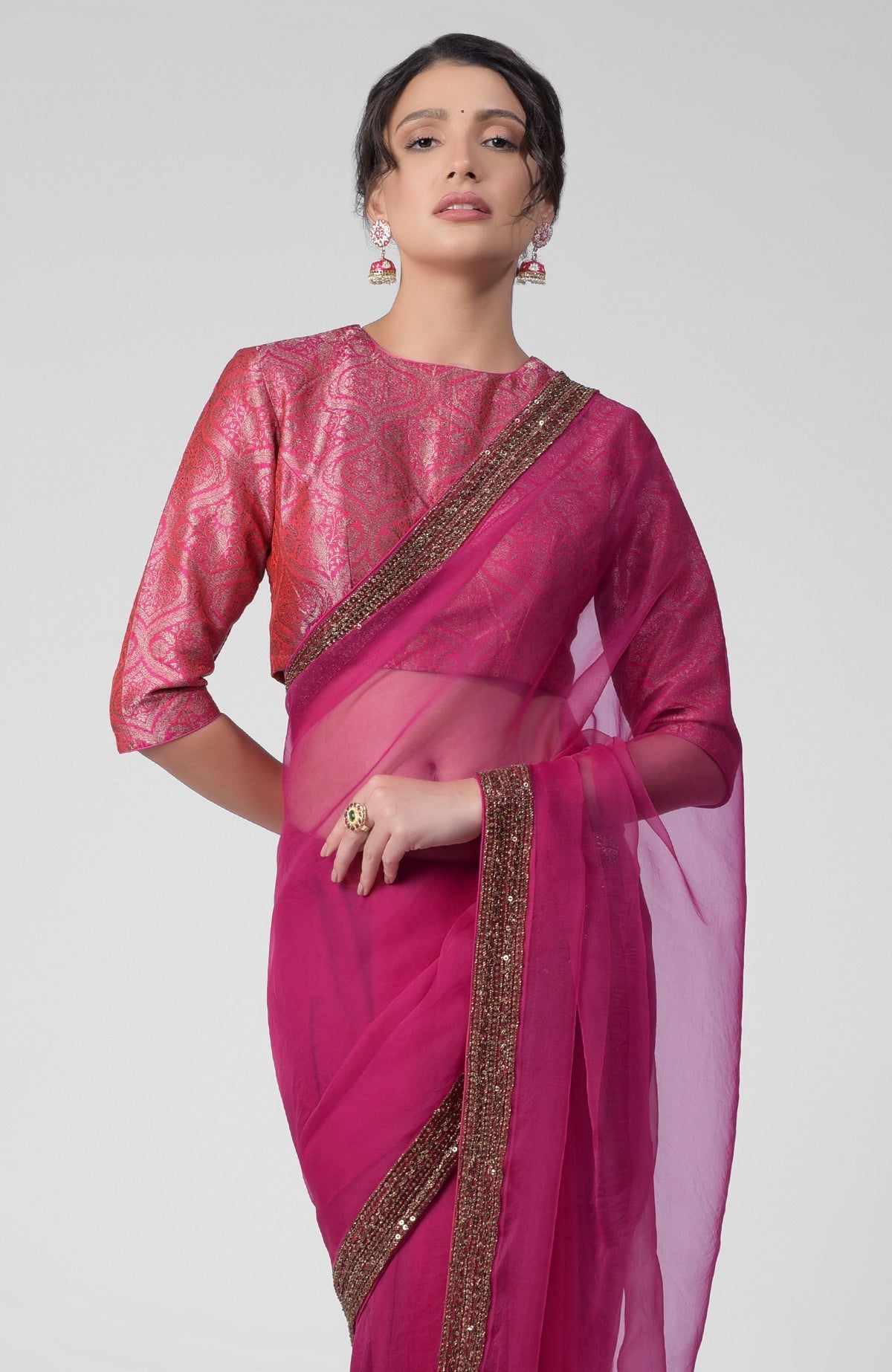 Fuchsia silk organza saree with gold zardozi border and silk brocade blouse with jewel neckline