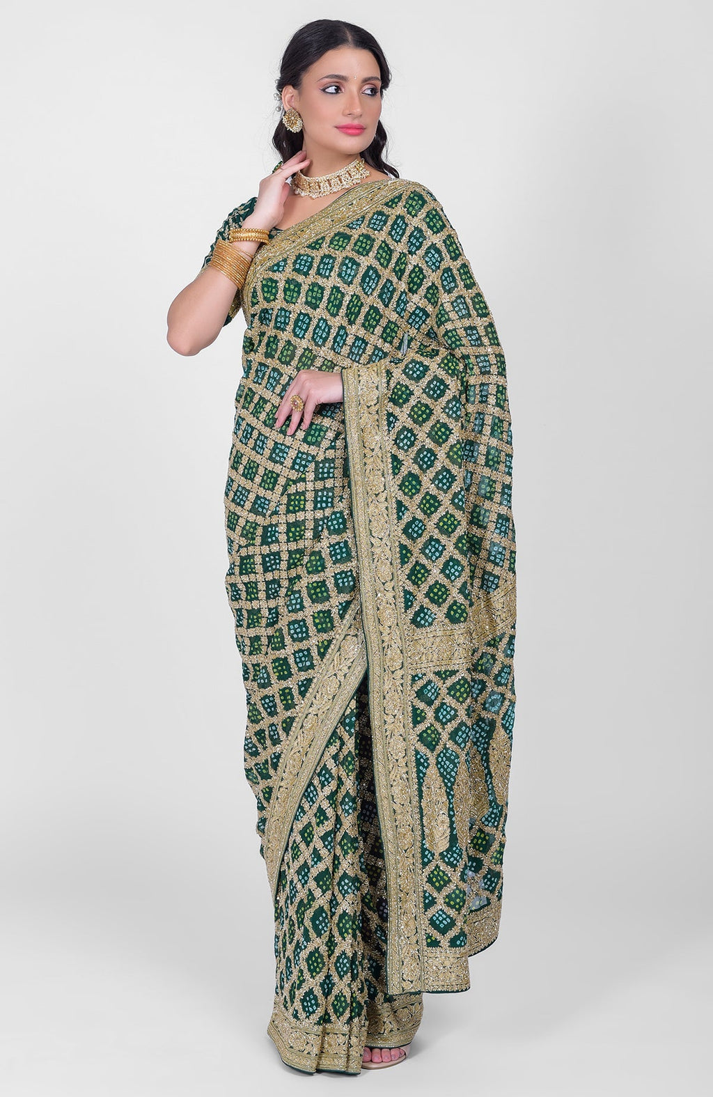 A woman models a bottle green Bandhej and Banarasi zari zardozi hand-embroidered saree.