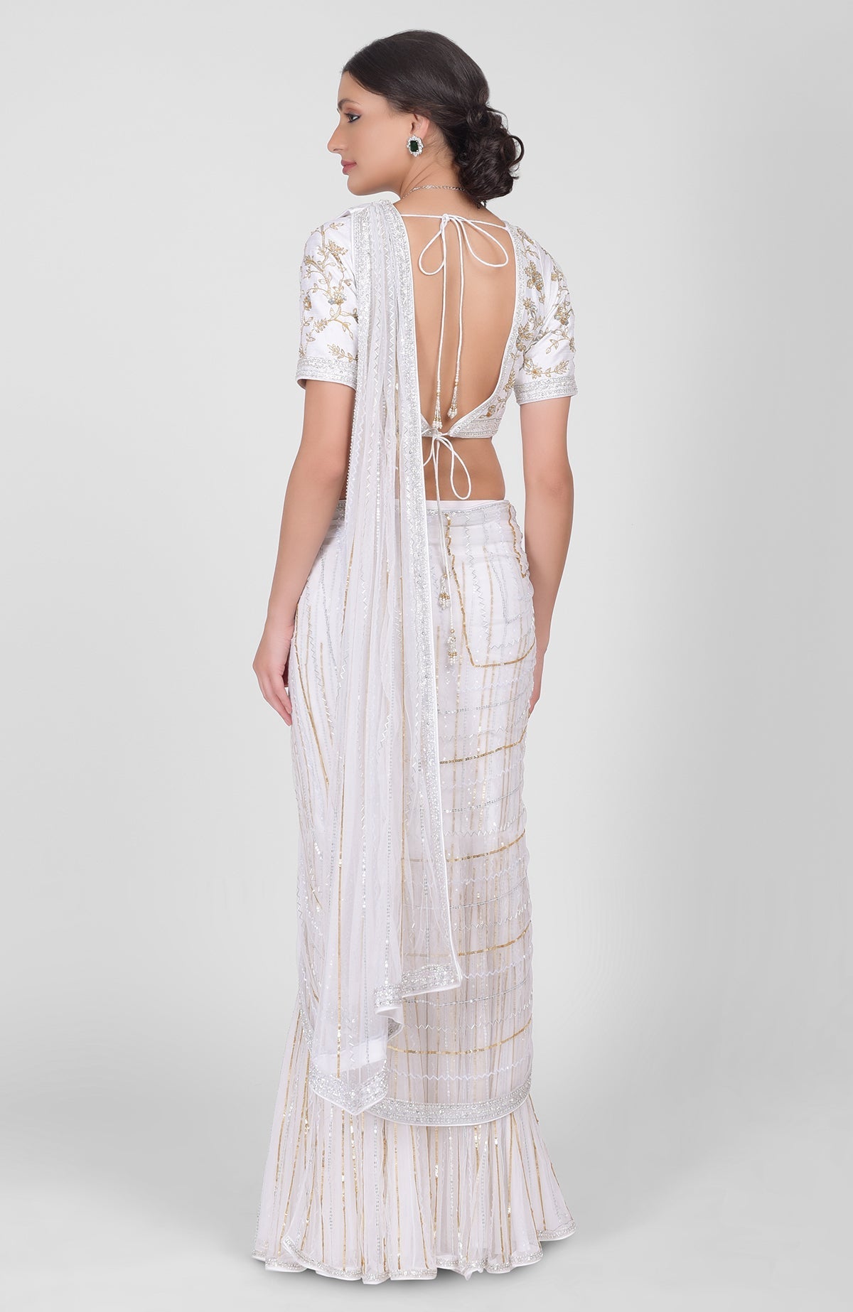 White saree with hand-embroidered gold, silver sequins, beads, paired with gold zari blouse