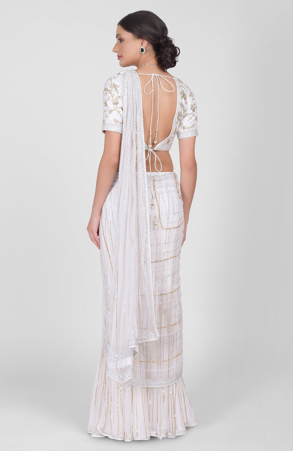 White tulle saree with gold, silver sequins and beads, paired with gold embroidered blouse.