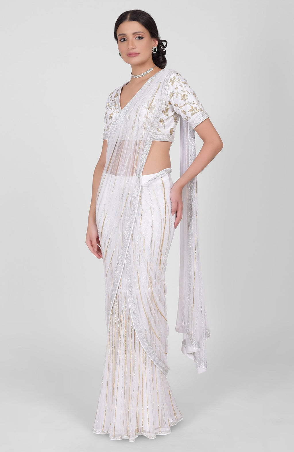 White tulle saree with gold, silver sequins and beads, paired with gold embroidered blouse.