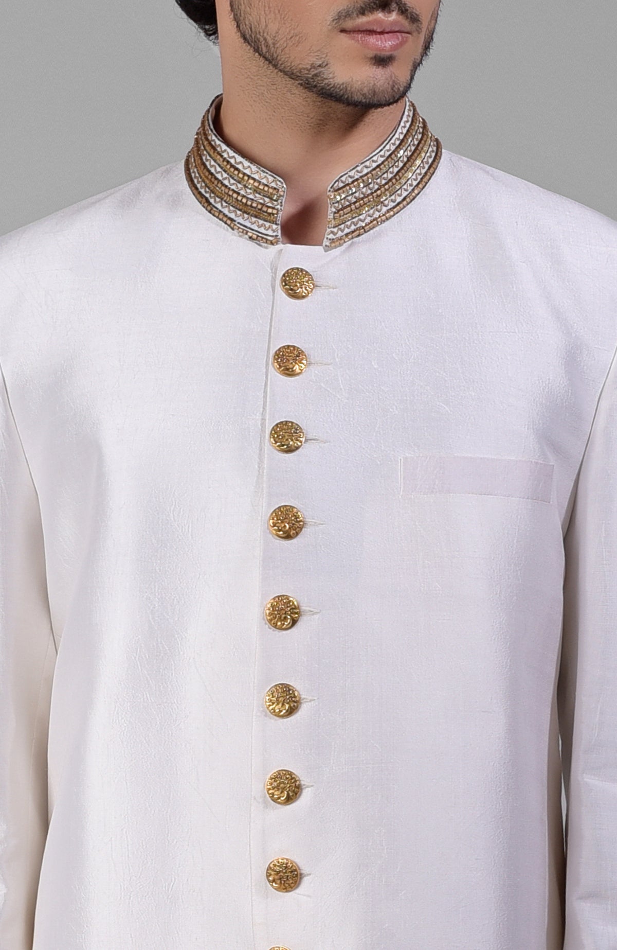 Ivory-gold silk bandhgala jacket with zardozi hand embroidery and golden buttons.
