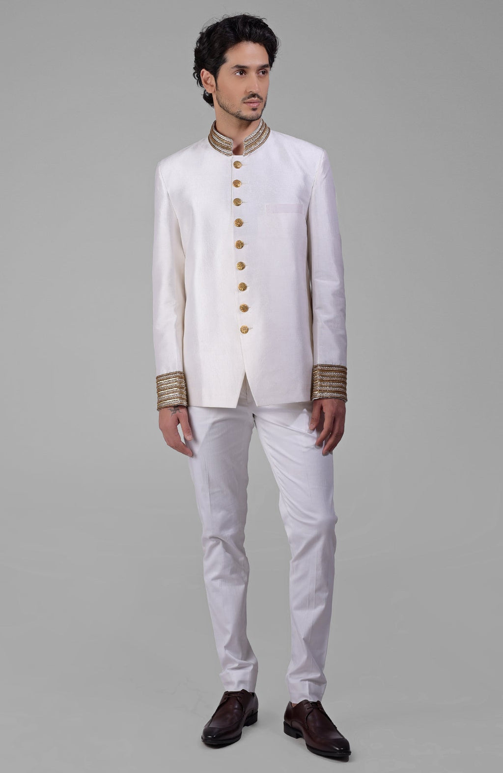 Ivory-gold silk bandhgala jacket with zardozi embroidery and golden buttons.