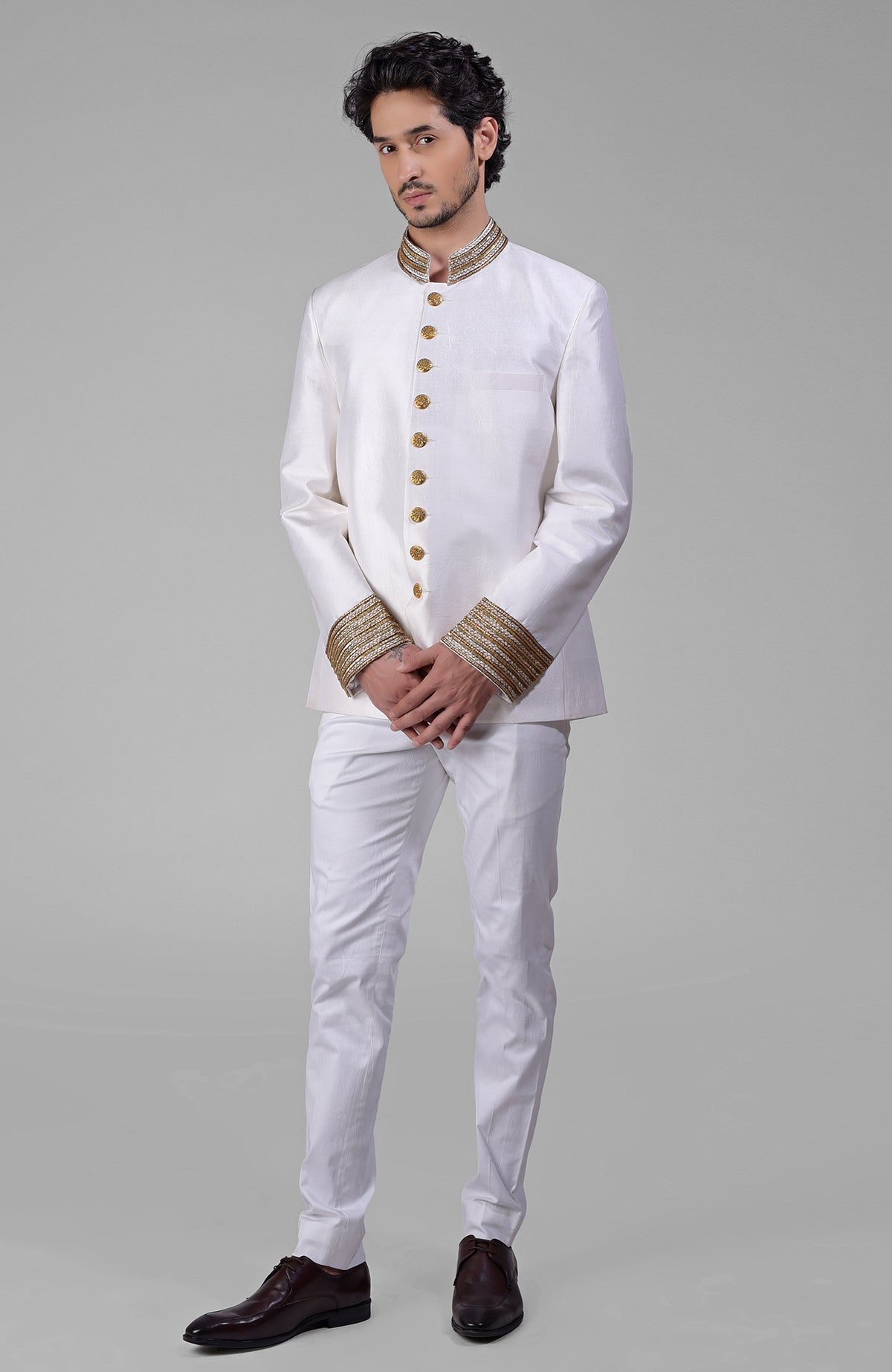 Black silk bandhgala jacket with intricate zardozi embroidery and matching tencil cotton pants.