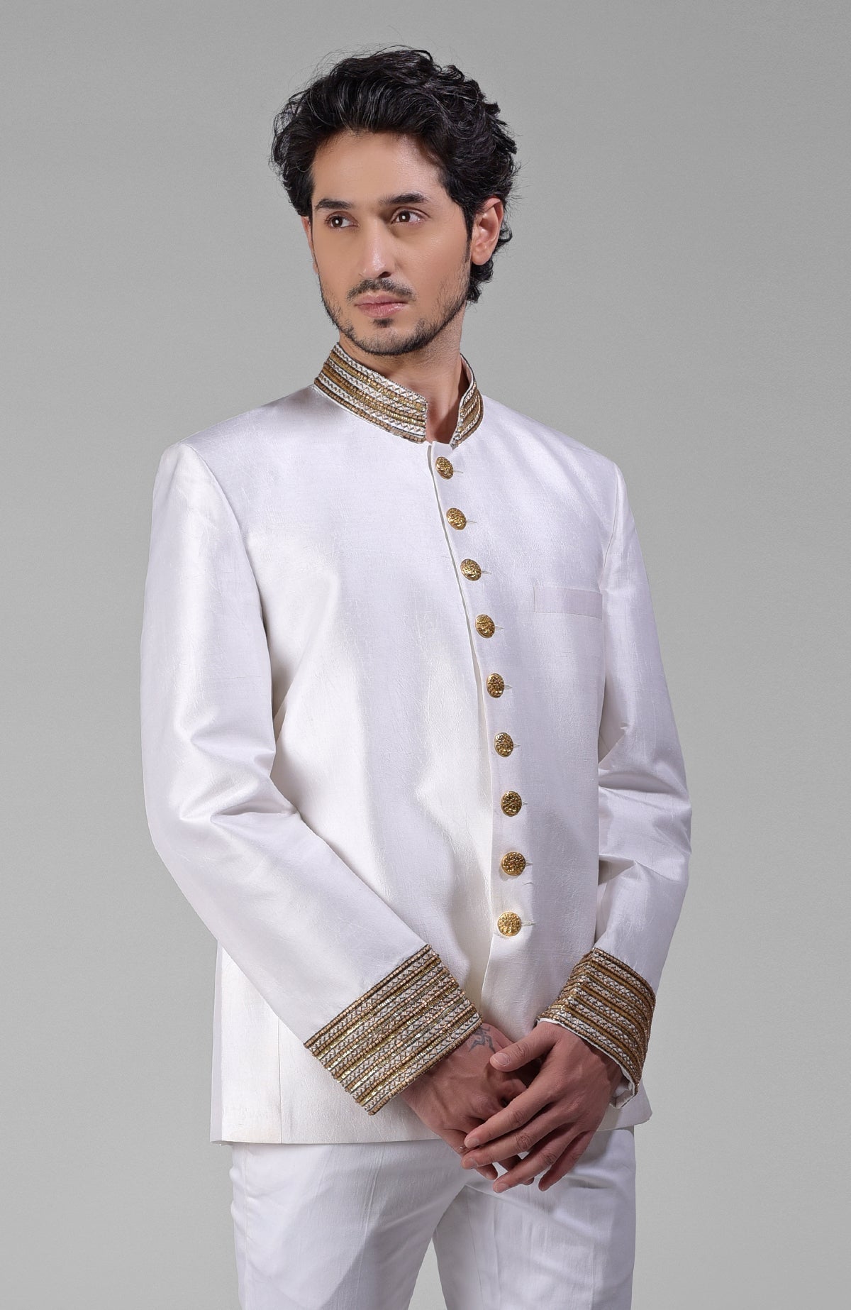 Ivory-gold silk bandhgala jacket with zardozi hand embroidery and golden buttons.