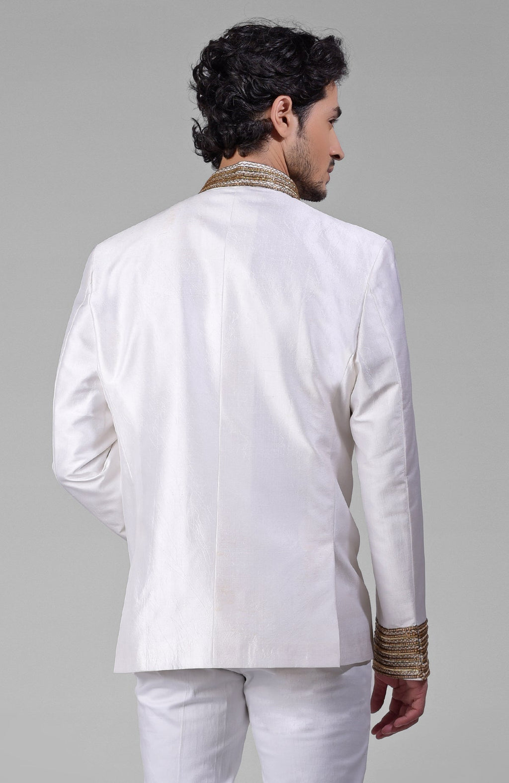 Back view of an ivory-gold zardozi hand-embroidered silk bandhgala jacket.