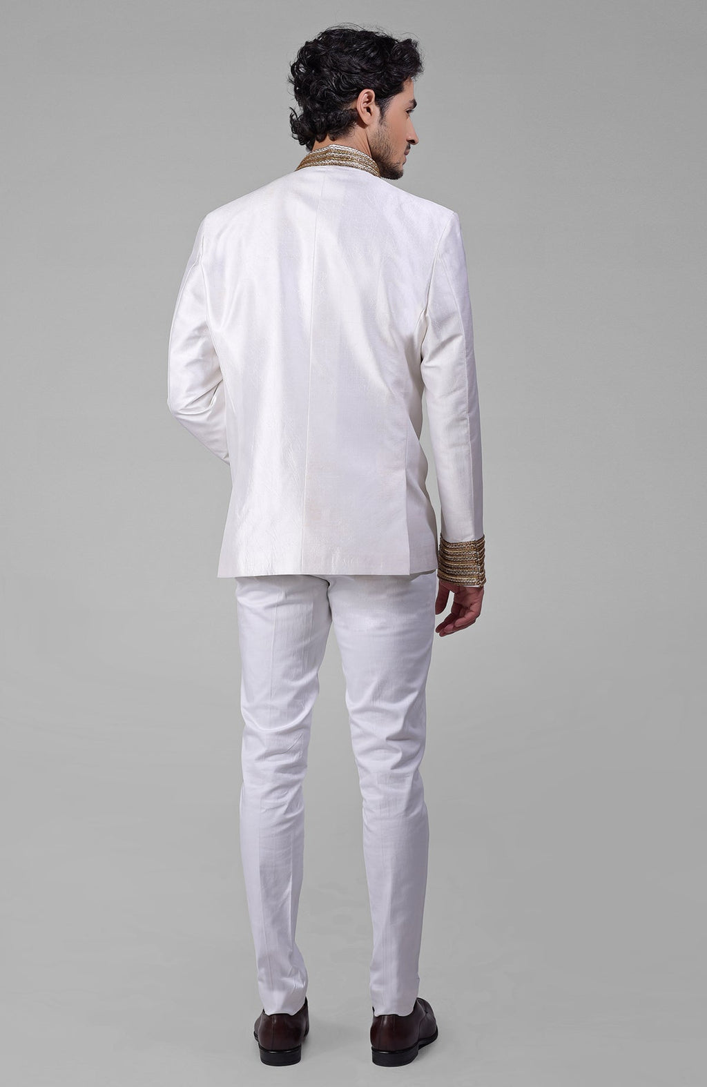 Ivory silk bandhgala jacket with gold zardozi embroidery and golden buttons paired with white pants