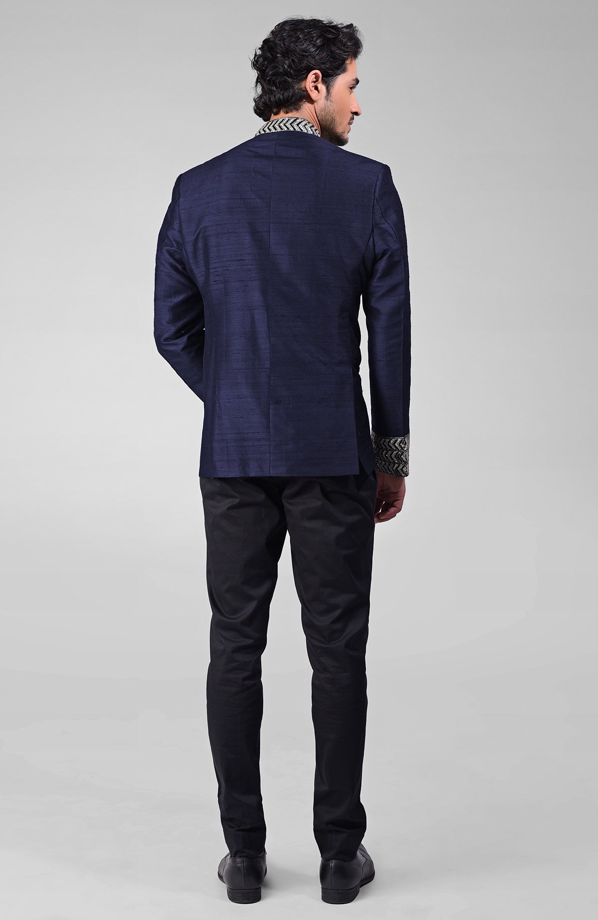 Navy blue silk bandhgala jacket with zardozi embroidery and matching tencil cotton pants.