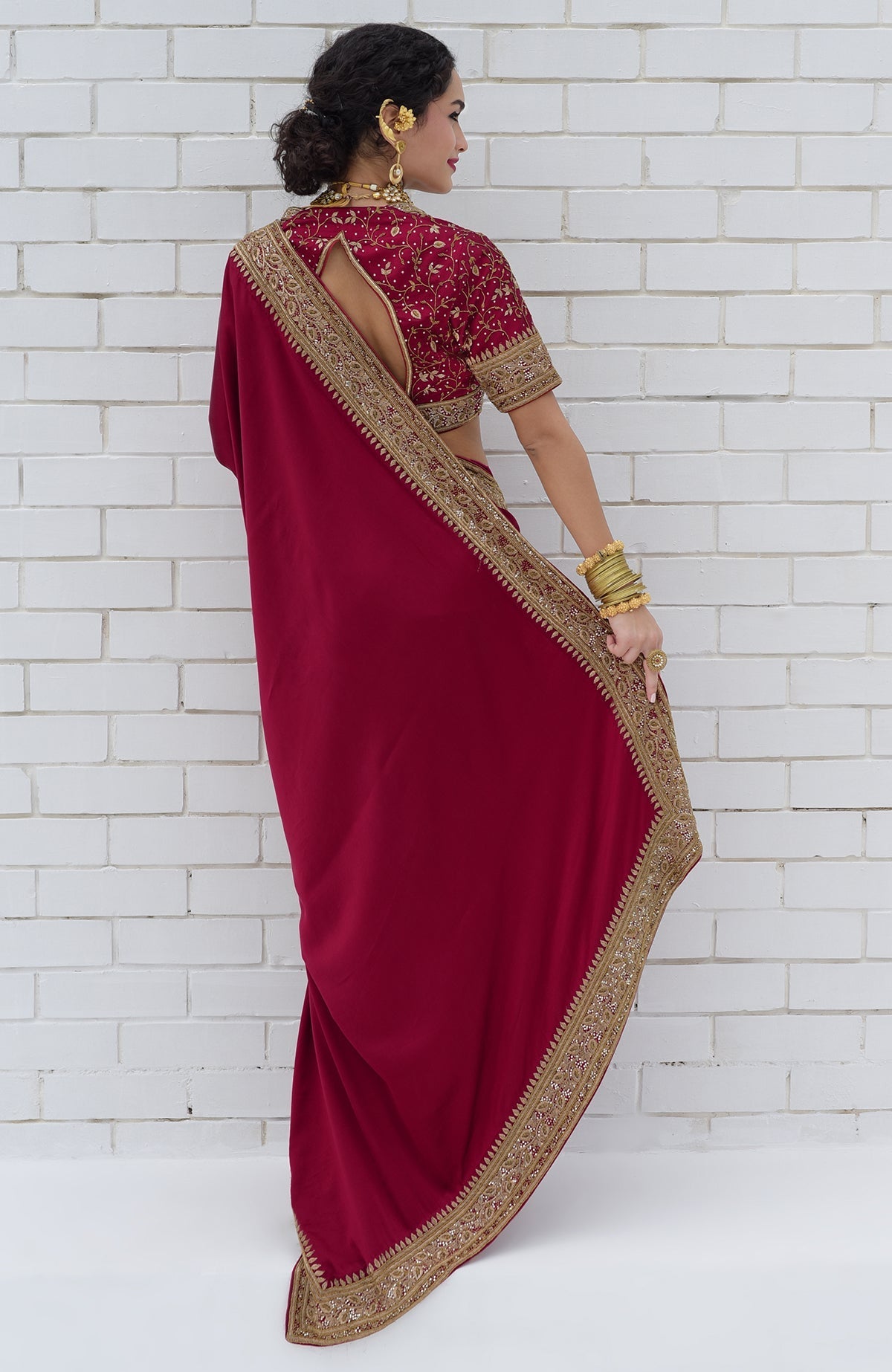 Blood red pure silk saree with gold zardozi hand embroidery and intricate beadwork borders.