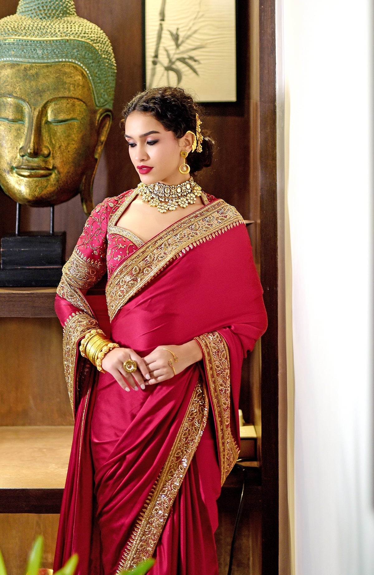 Blood red pure silk saree with gold hand-embroidered zardozi and bead work and matching blouse.