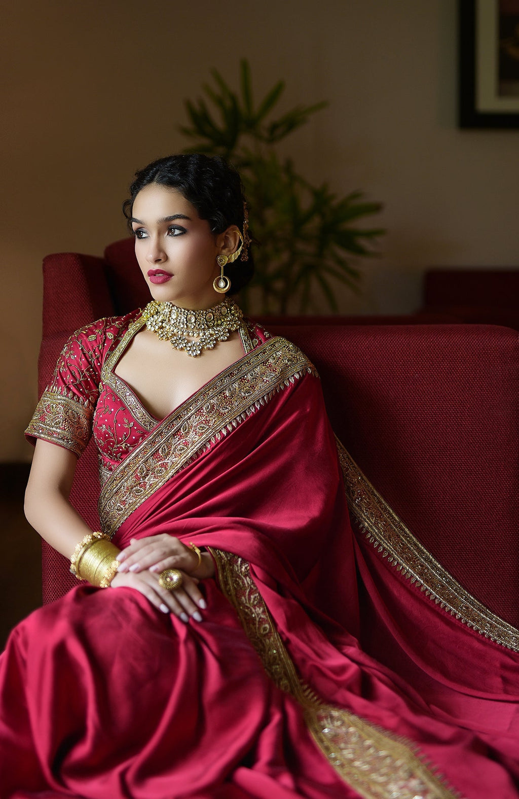 Blood red pure silk saree with gold zardozi hand embroidery and beadwork, paired with matching blouse.