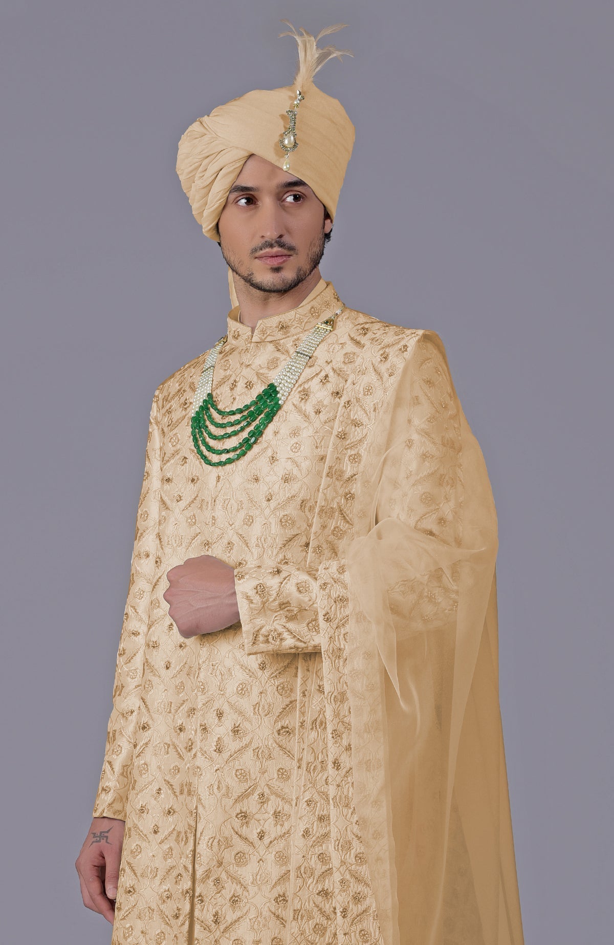 Golden sherwani with floral embroidery, silk organza dupatta, and bead embellishments.