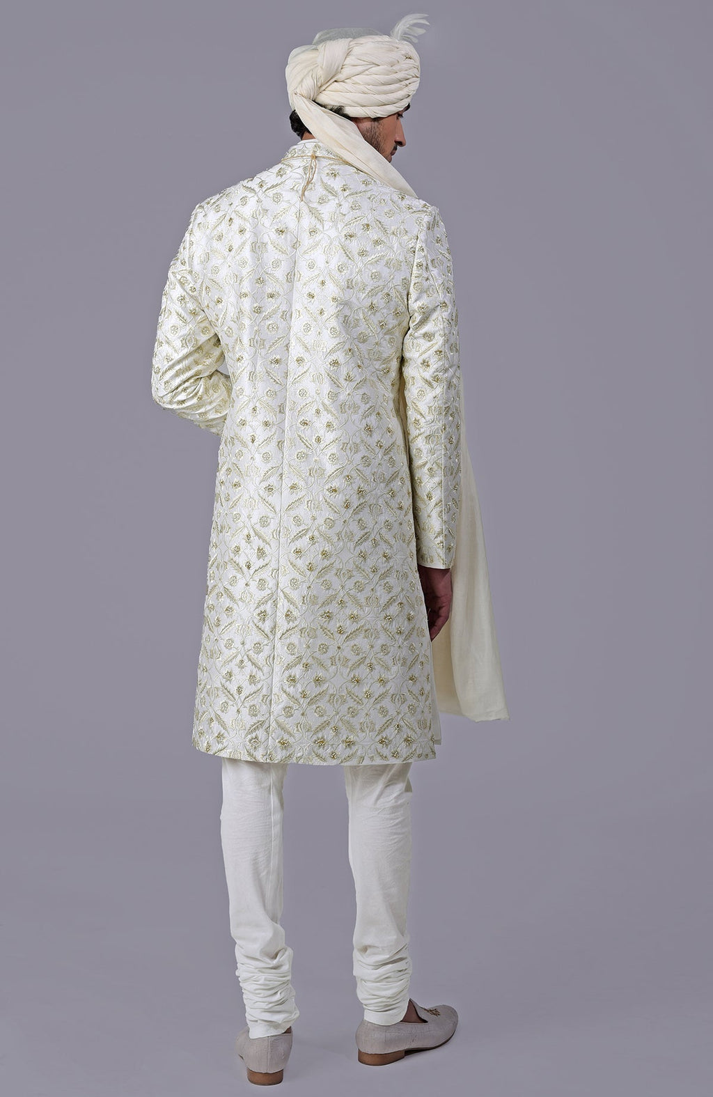 Ivory and gold sherwani with floral embroidery and silk organza dupatta in a five-piece set.