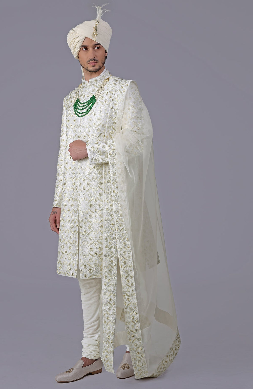 Ivory and gold sherwani with floral embroidery, silk organza dupatta, and bead embellishments.