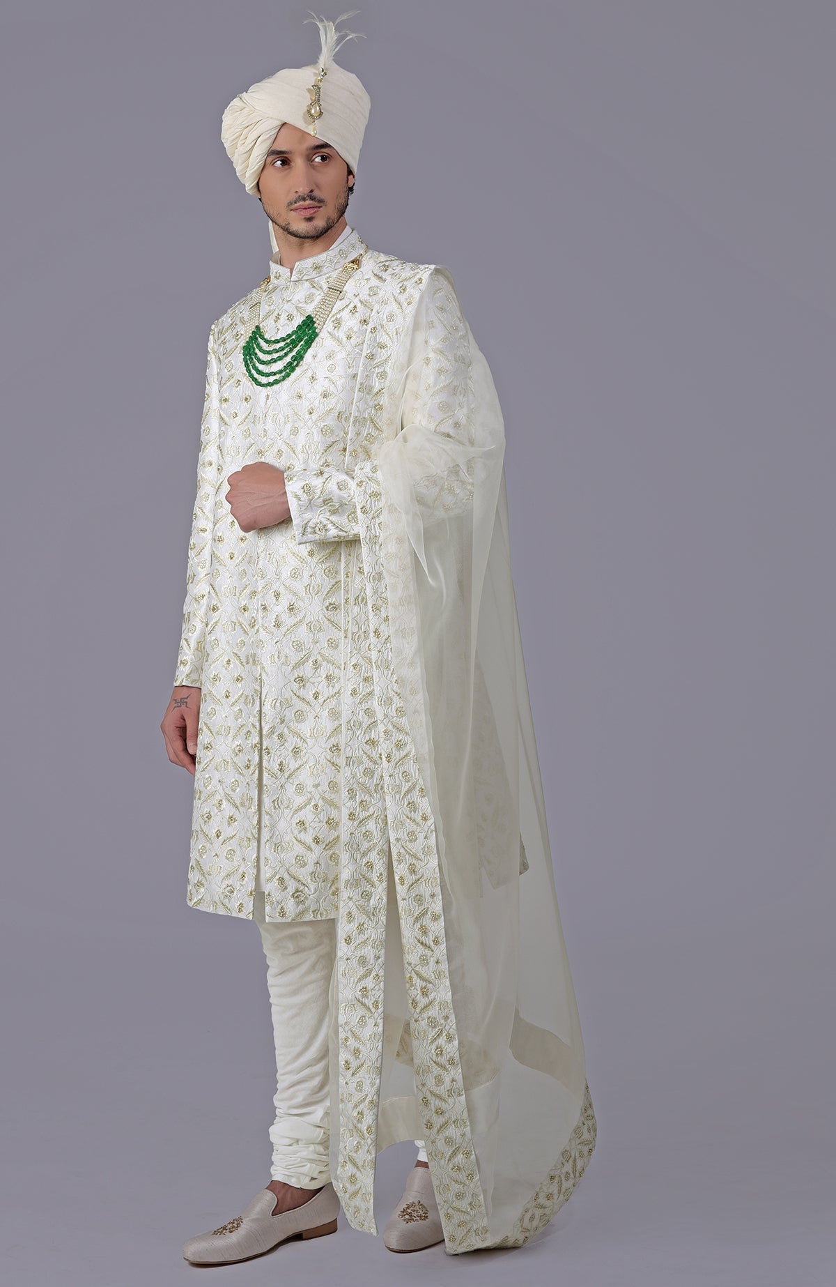 Ivory and gold sherwani with floral embroidery, silk organza dupatta, and bead embellishments.