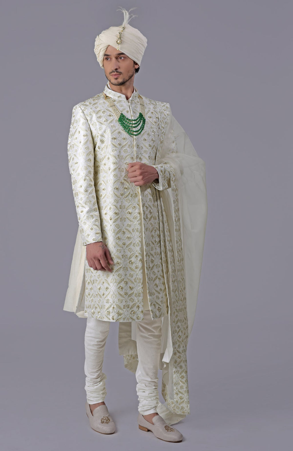 Ivory and gold sherwani with floral embroidery, silk organza dupatta, and bead embellishments.