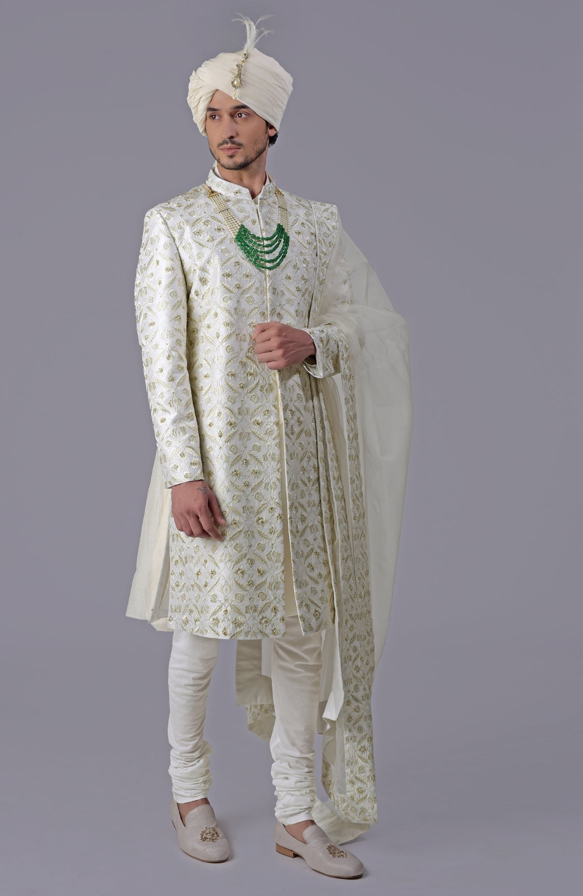 Ivory and gold sherwani with floral embroidery, silk organza dupatta, and bead embellishments.
