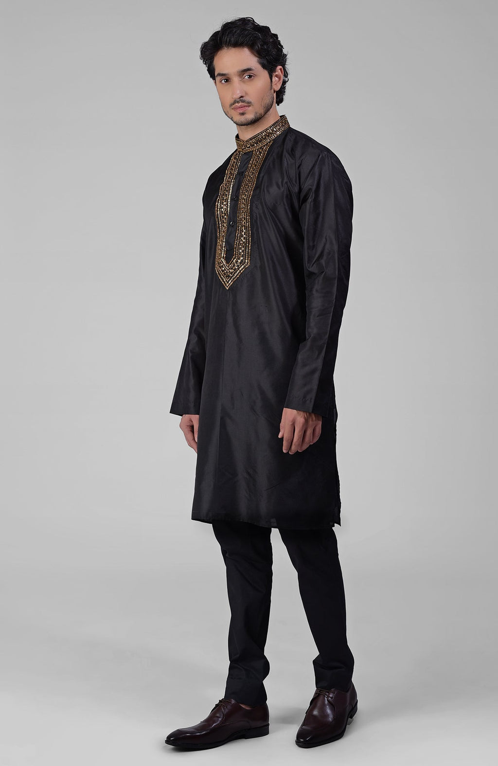 Black silk kurta set with zardozi embroidery, beadwork, sequins, and matching pants.