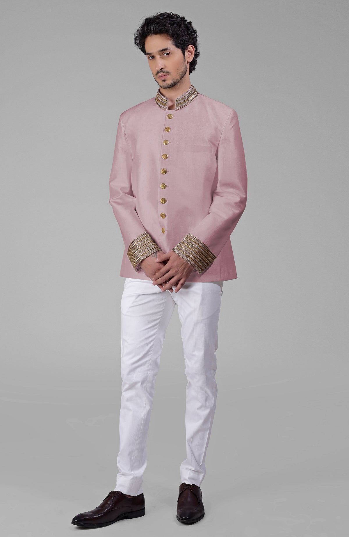 Gold silk bandhgala jacket with zardozi embroidery, beadwork, sequins, and golden buttons paired with white pants